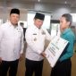 Pj Gubernur NTB, Hassanudin menyerahkan bantuan secara simbolis kepada siswa berprestasi  kurang mampu. Foto Dedi Shd.